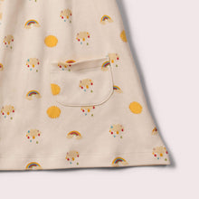 Load image into Gallery viewer,       Little-Green-Radicals-Cream-Pocket-Playdays-Dress-With-Sunshine-And-Rainbow-Print-Closeup-View
