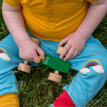 Lade das Bild in den Galerie-Viewer,     Little-Green-Radicals_Blue-Yellow-And-Red-Patch-Joggers-With-Rainbow-Print-Kid-Closeup
